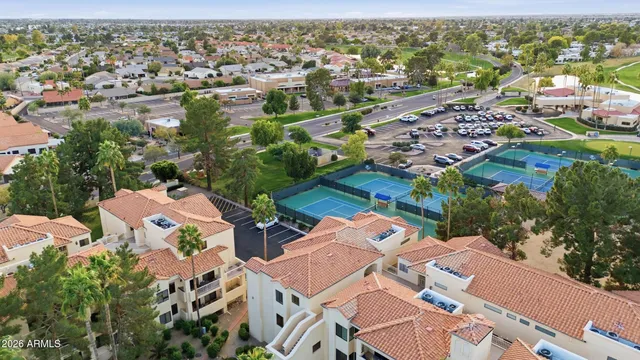 an aerial view of residential houses with outdoor space and trees