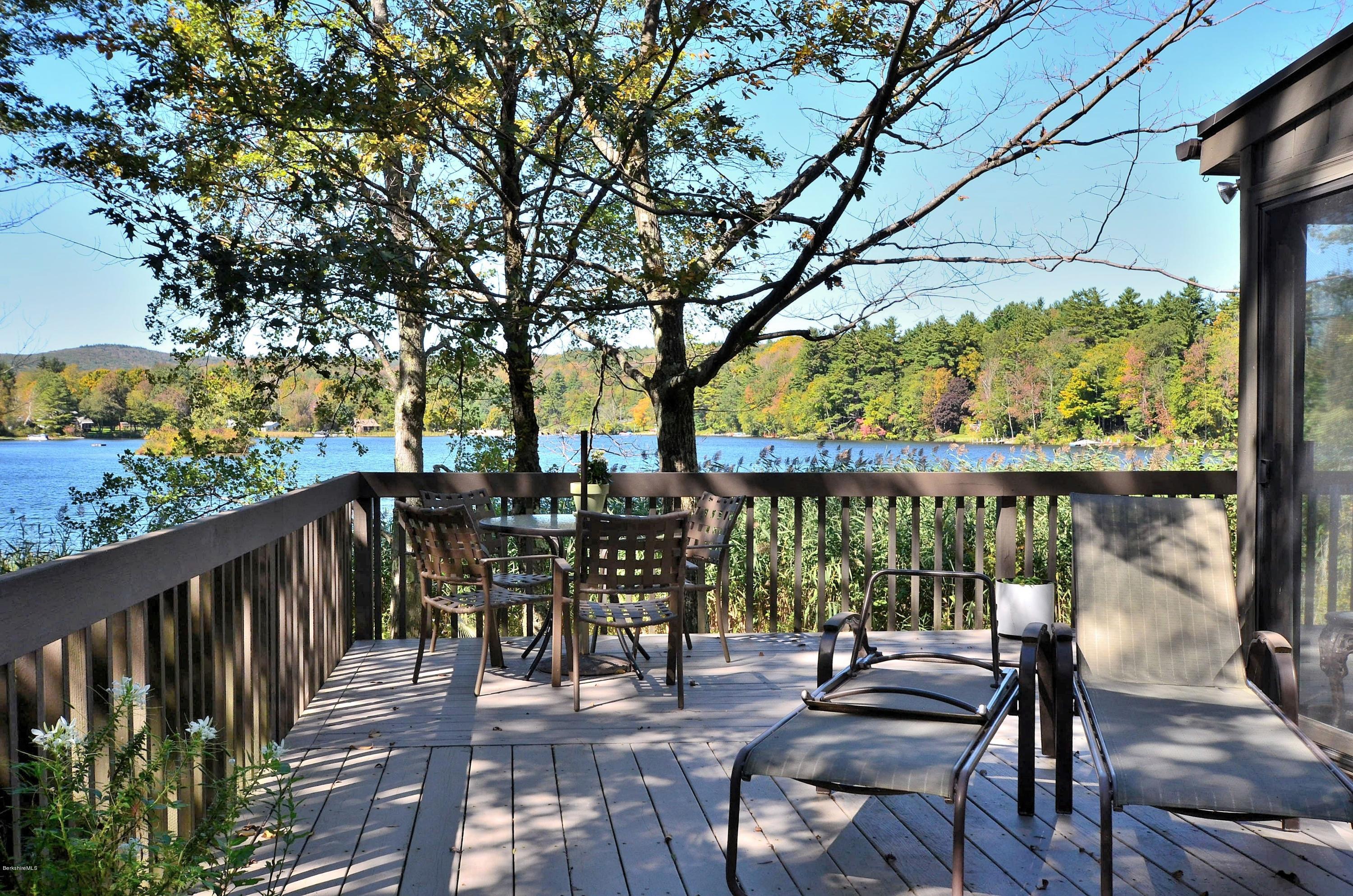 a view of balcony with chairs and wooden fence