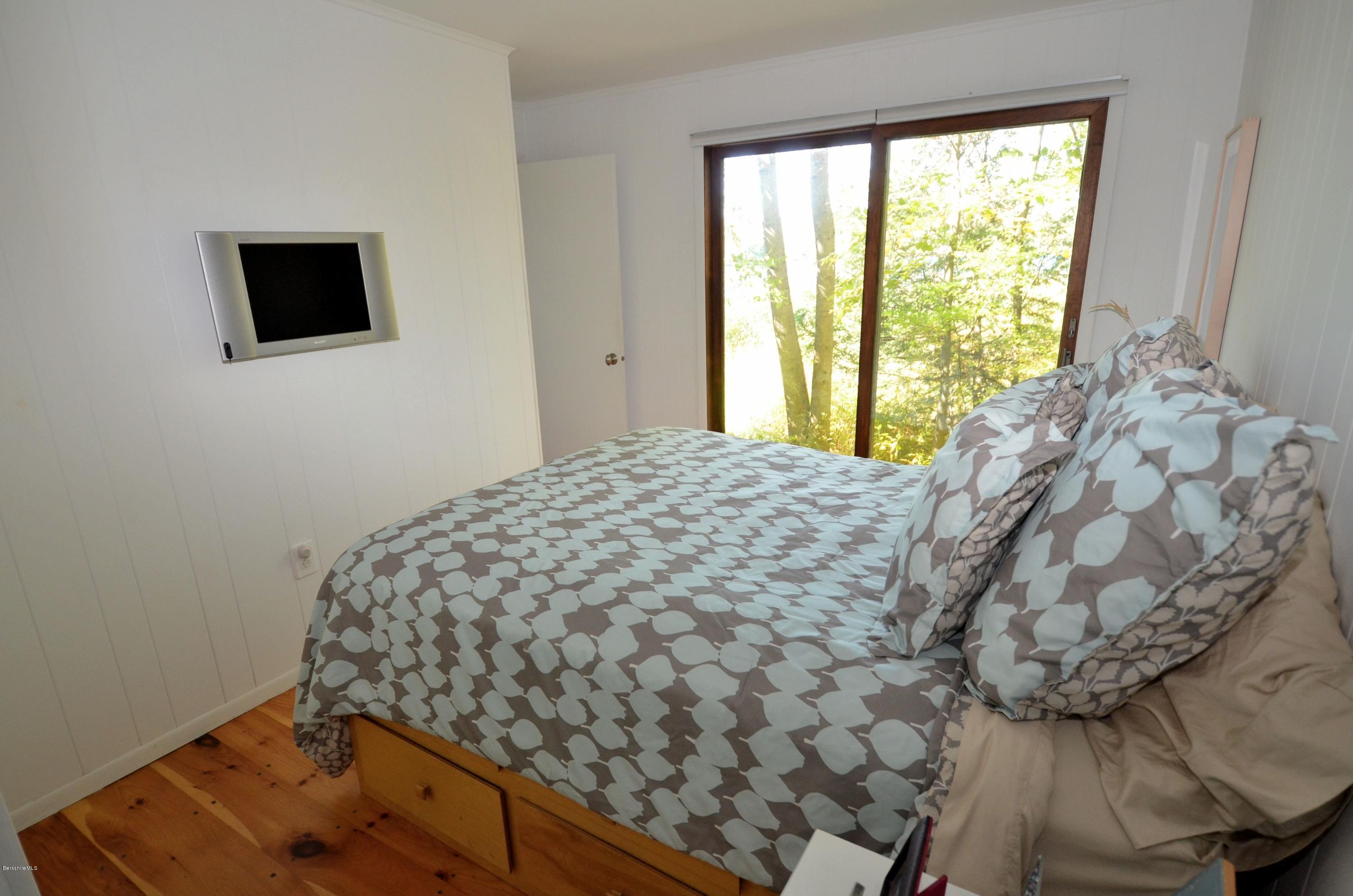 16 Point Road Monterey, MA 01245 - Photo 18 of 18 a bed sitting in a bedroom next to a window