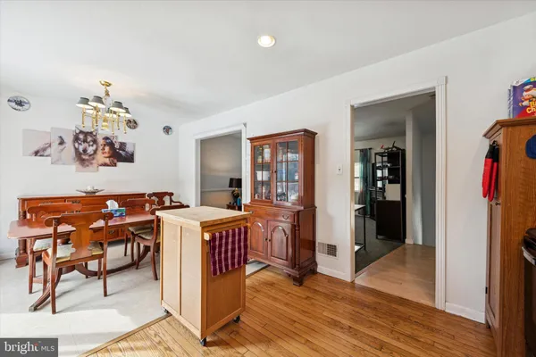 a view of a workspace with furniture and wooden floor