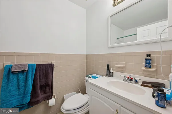 a bathroom with a sink a toilet and vanity