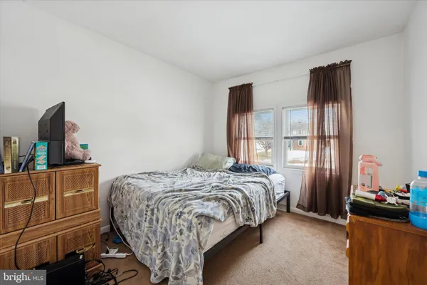 a bedroom with a bed and flat screen tv