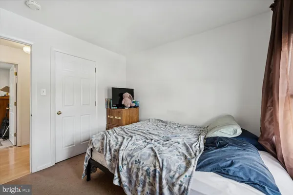 a bedroom with a bed and a mirror