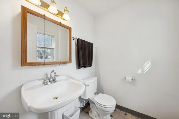 a bathroom with a sink a toilet and mirror