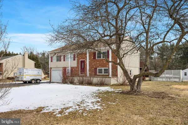 a view of a house with a yard covered in snow