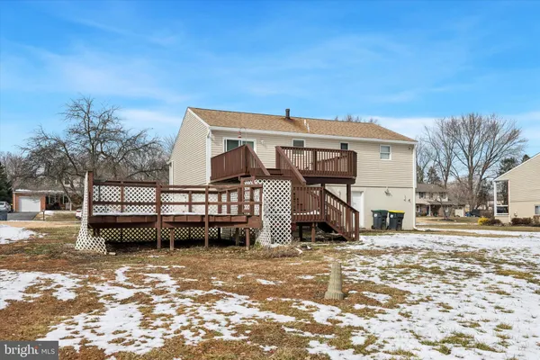a view of a house with wooden fence