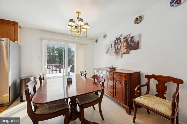 a view of a dining room with furniture and chandelier