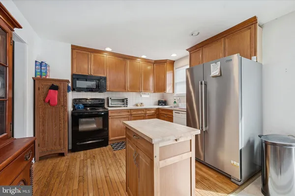 a kitchen with a refrigerator a stove top oven a sink and dishwasher
