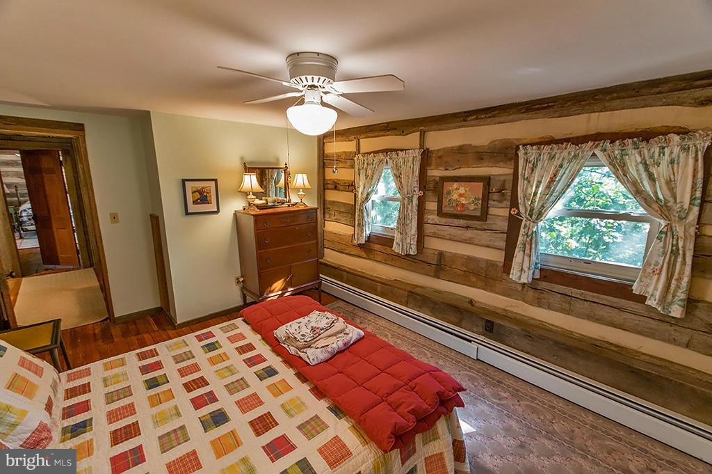 1209 Libby's Ridge Road Berkeley Springs, WV 25411 - Photo 25 of 30 a bedroom with a bed and a chandelier