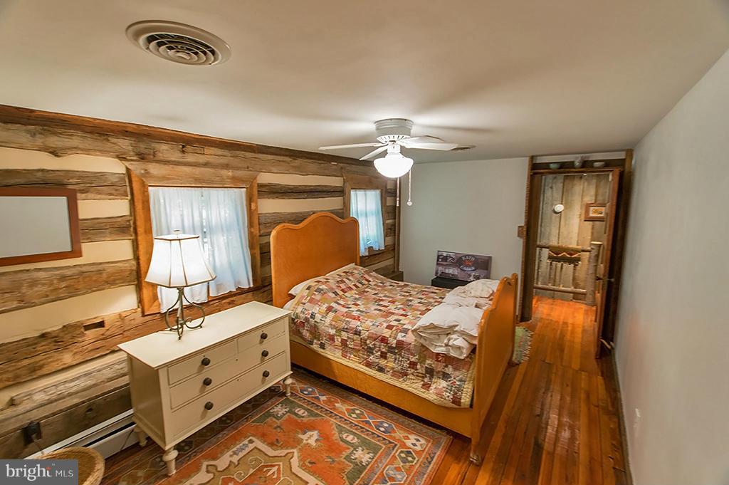 1209 Libby's Ridge Road Berkeley Springs, WV 25411 - Photo 26 of 30 a bed room with a bed and a dresser