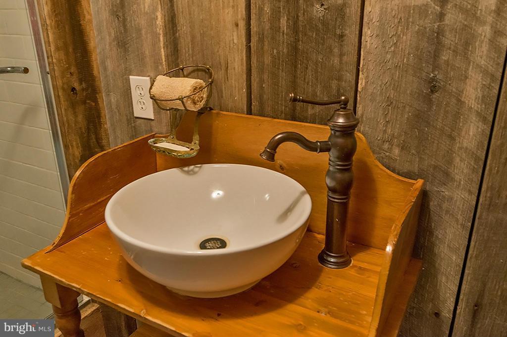 1209 Libby's Ridge Road Berkeley Springs, WV 25411 - Photo 29 of 30 a bathroom with a sink and mirror
