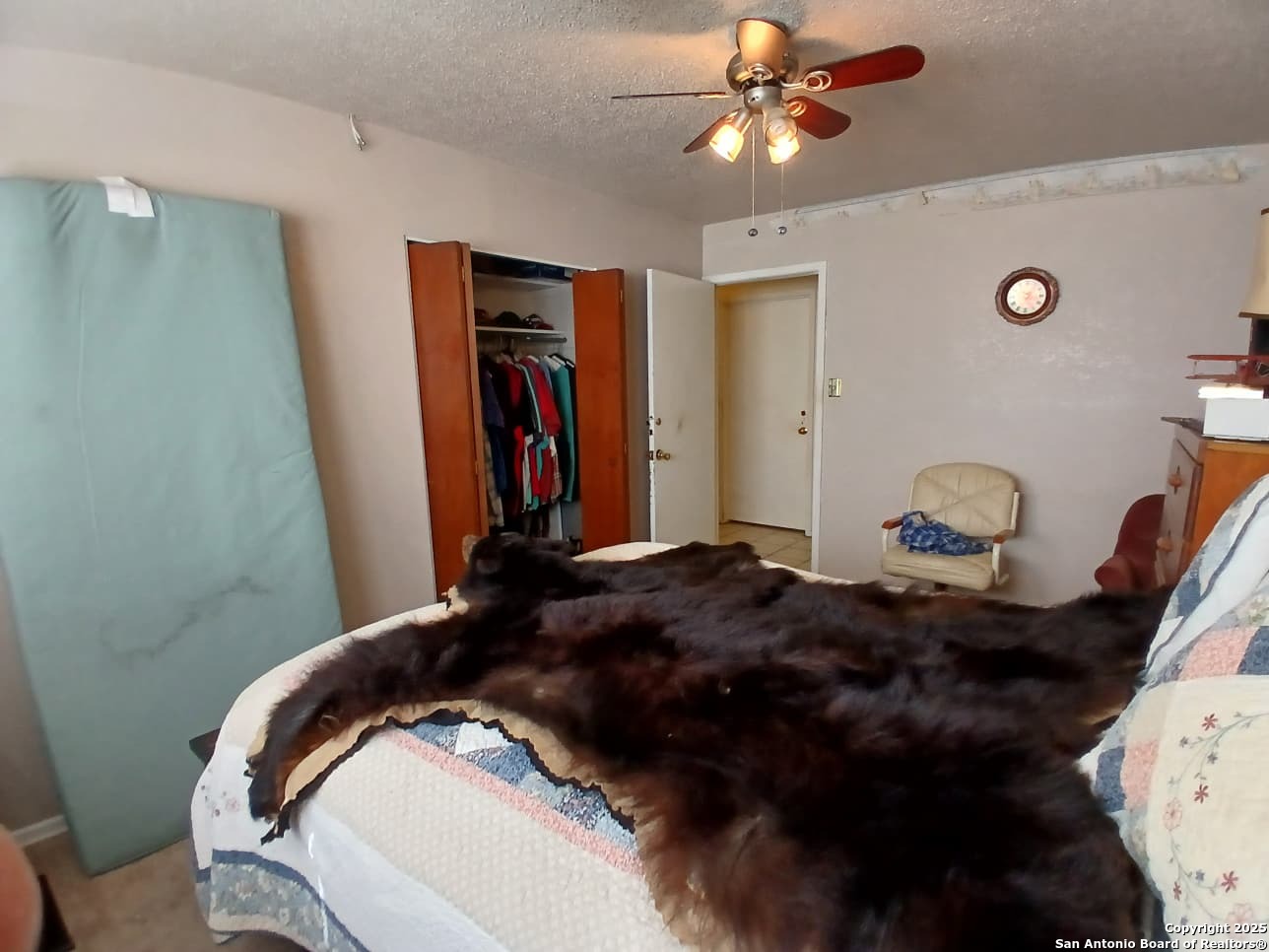 706 Thomaston River Road Cuero, TX 77954 - Photo 27 of 46 a bedroom with a bed and a chandelier