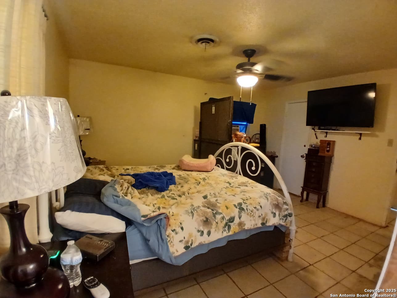 706 Thomaston River Road Cuero, TX 77954 - Photo 28 of 46 a bedroom with a bed and a flat screen tv