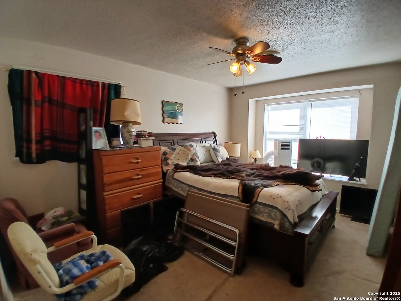 706 Thomaston River Road Cuero, TX 77954 - Photo 29 of 46 a bedroom with a bed and a chandelier