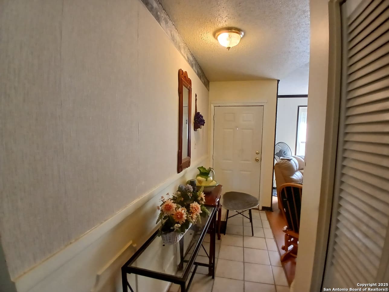 706 Thomaston River Road Cuero, TX 77954 - Photo 40 of 46 a view of a hallway with couches and potted plant on the wall