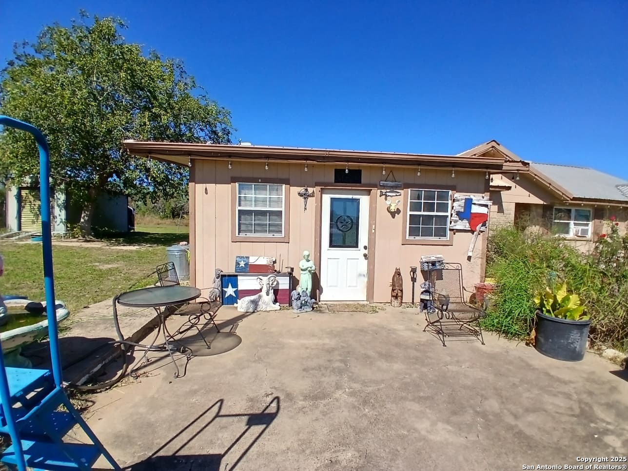 706 Thomaston River Road Cuero, TX 77954 - Photo 4 of 46 a view of a house with backyard sitting area and garden
