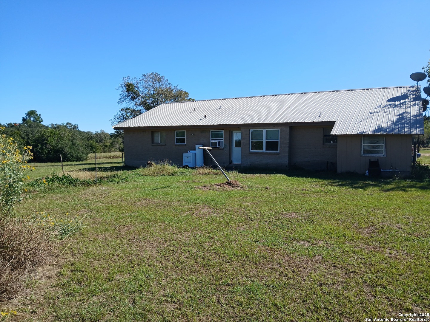 706 Thomaston River Road Cuero, TX 77954 - Photo 46 of 46 a view of a house with backyard and a tree