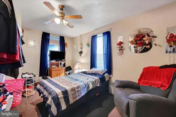 a bedroom with a bed couch and window
