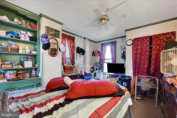 a bedroom with bed and tv