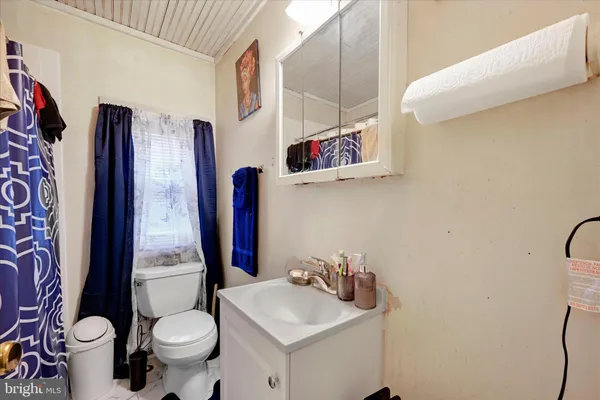 a bathroom with a sink mirror vanity and toilet