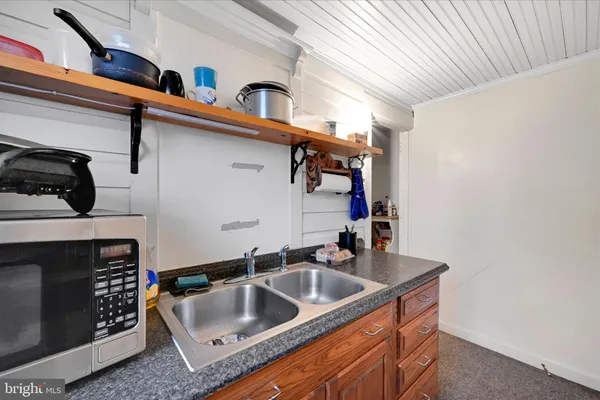 a kitchen with a sink and a stove top oven