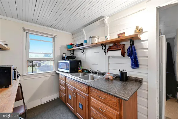 a kitchen with stainless steel appliances granite countertop a sink and cabinets