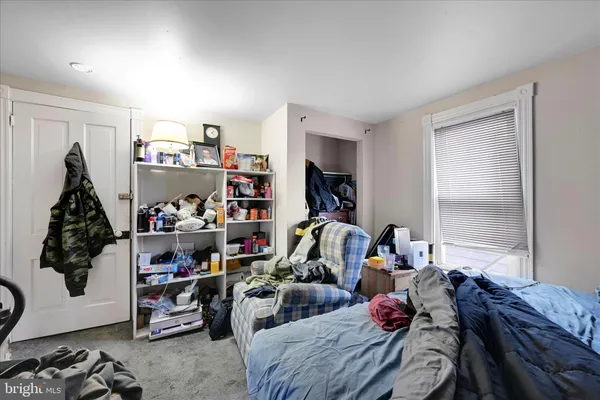 a bedroom with furniture and a window