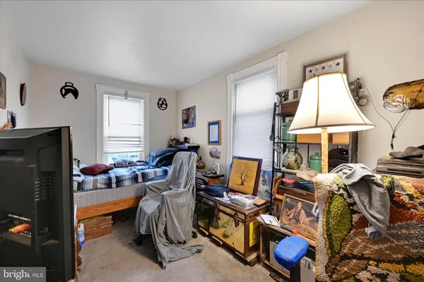 a living room with furniture a fireplace and a window