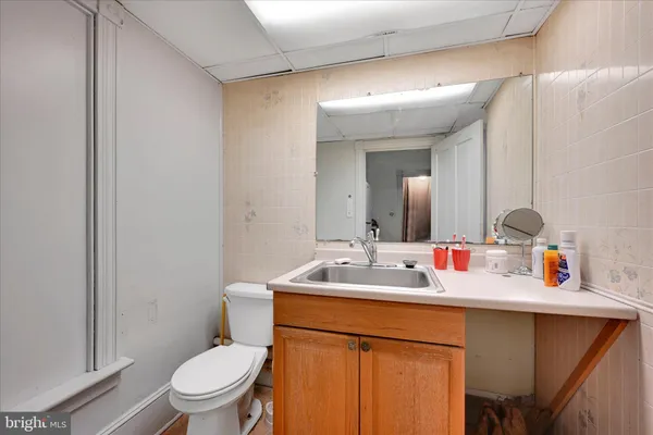 a bathroom with a toilet sink and mirror