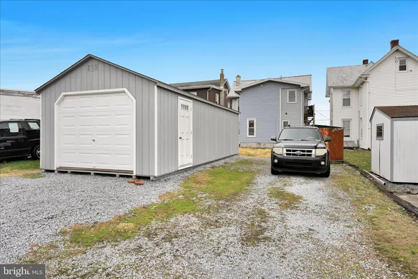 a view of a house with a car parked in front of it