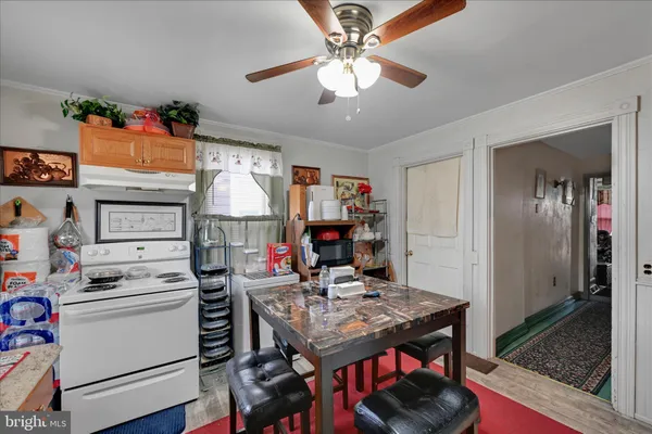 a kitchen that has a lot of cabinets stove and refrigerator