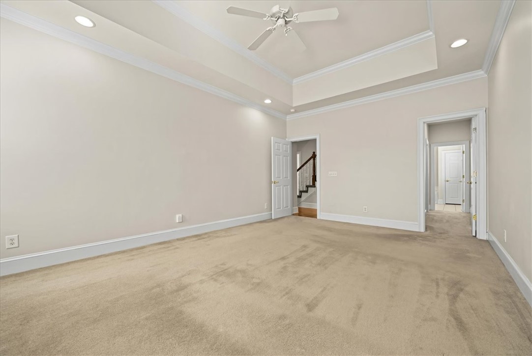 38 Angus Run Seneca, SC 29672 - Photo 29 of 46 An inviting room boasts comfortable carpet and elegant tray ceilings, perfect for relaxation.