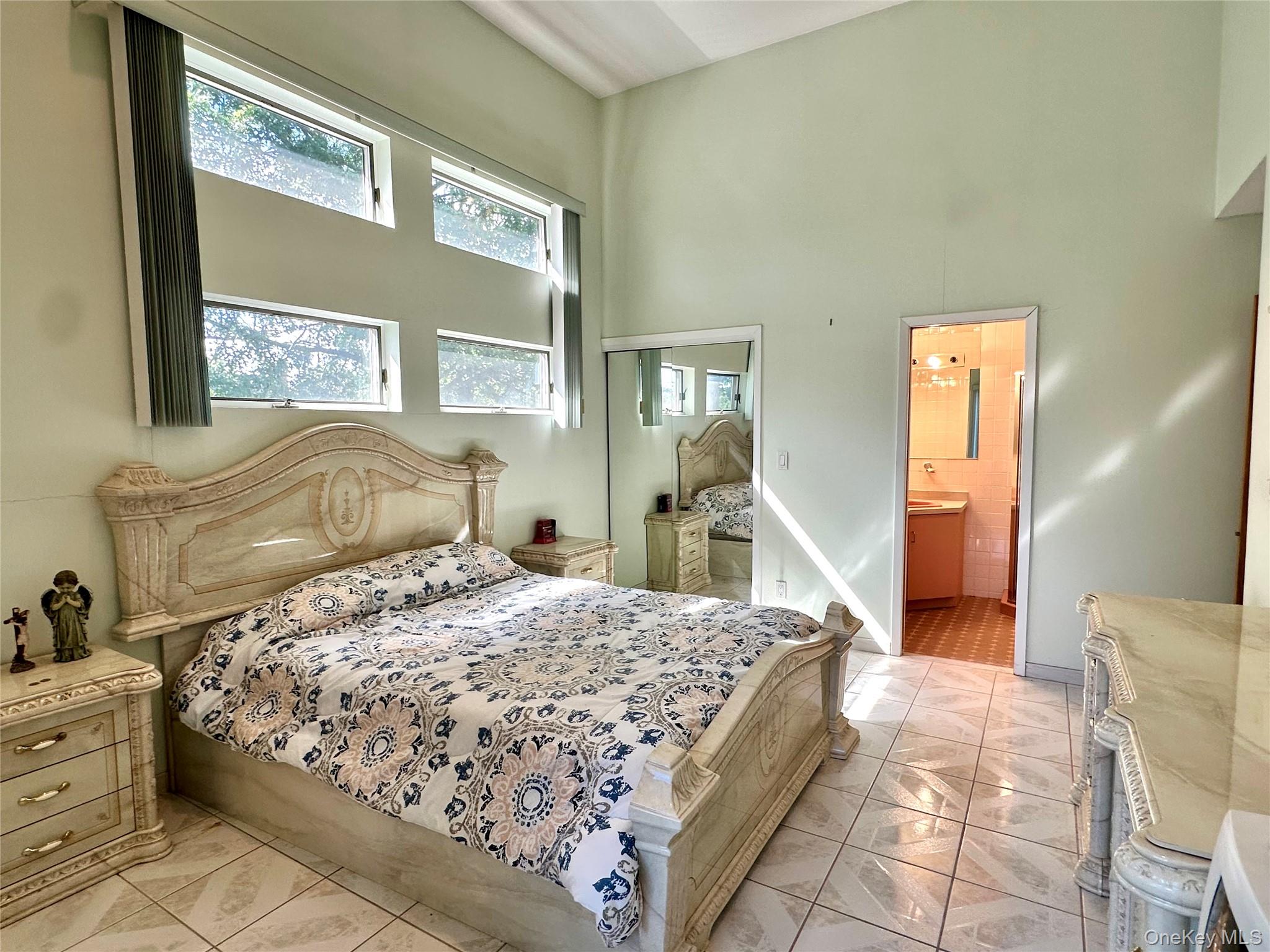 1027 Windermere Road Franklin Square, NY 11010 - Photo 11 of 43 a bedroom with a large bed and a dresser