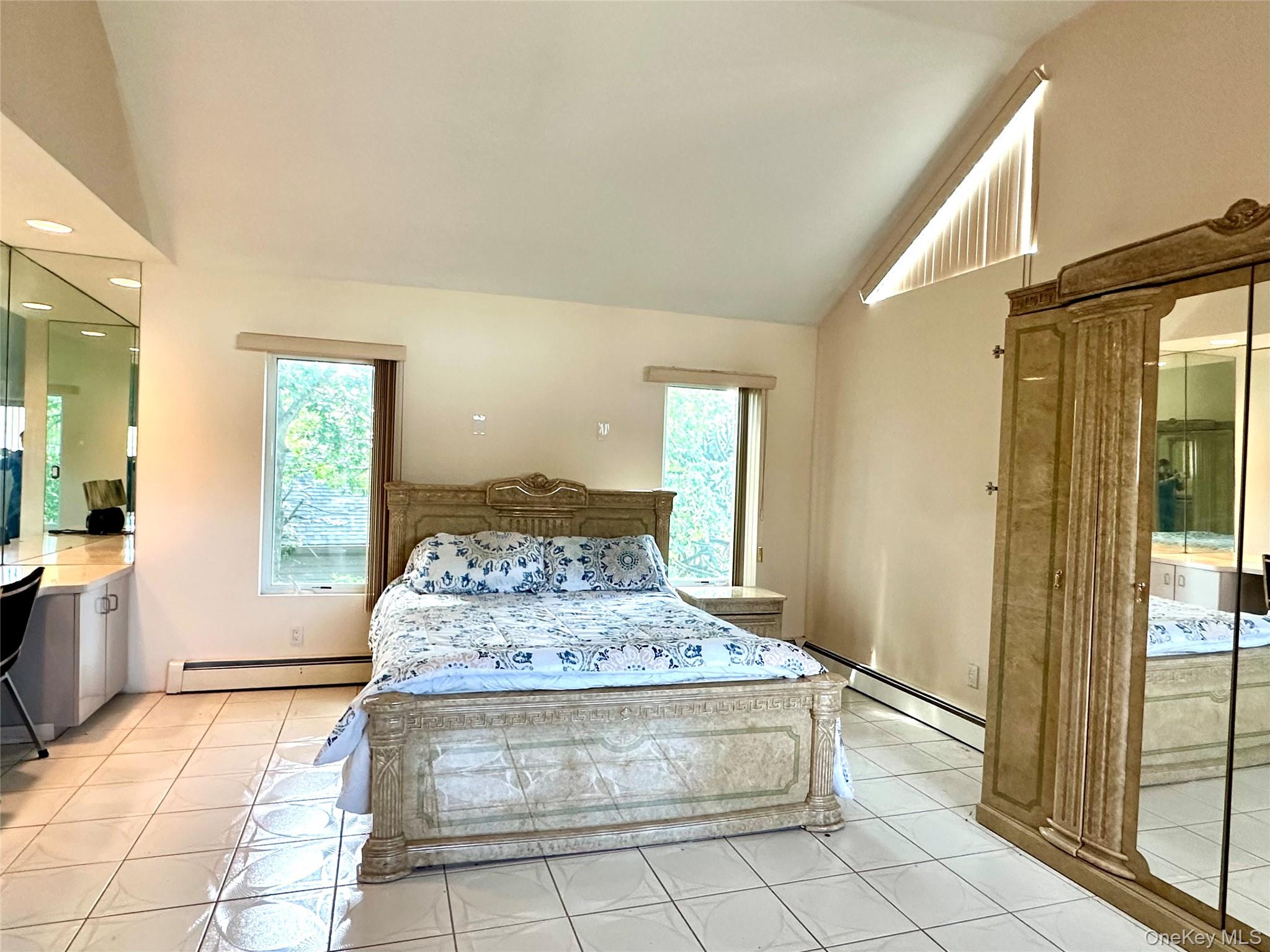 1027 Windermere Road Franklin Square, NY 11010 - Photo 18 of 43 a spacious bathroom with a granite countertop sink a mirror and a shower