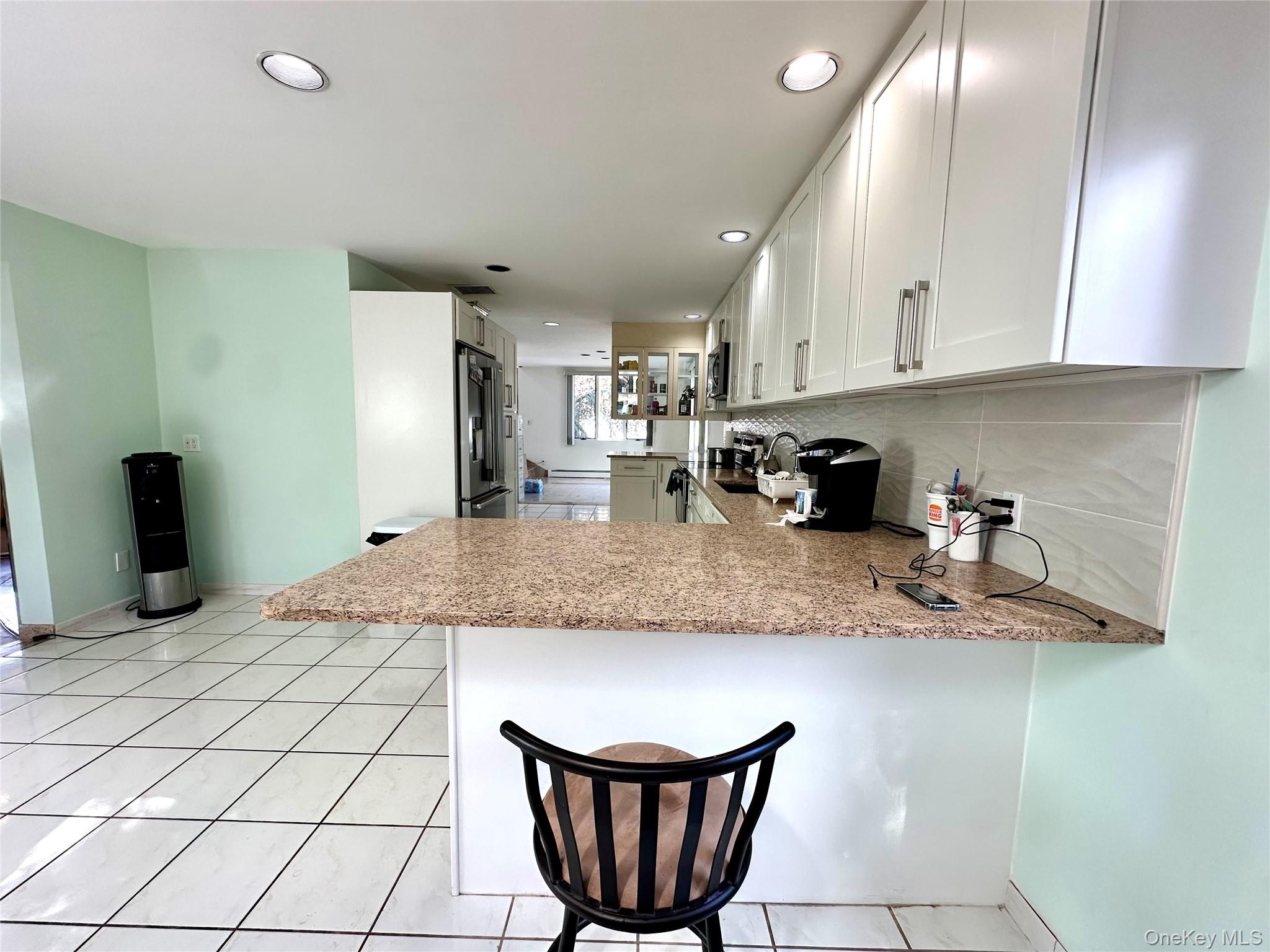 1027 Windermere Road Franklin Square, NY 11010 - Photo 21 of 43 a kitchen with stainless steel appliances granite countertop a sink refrigerator and cabinets