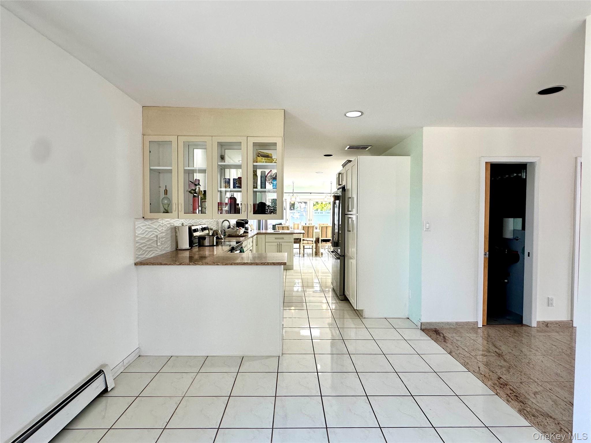 1027 Windermere Road Franklin Square, NY 11010 - Photo 22 of 43 a kitchen with stainless steel appliances a refrigerator and a counter top space