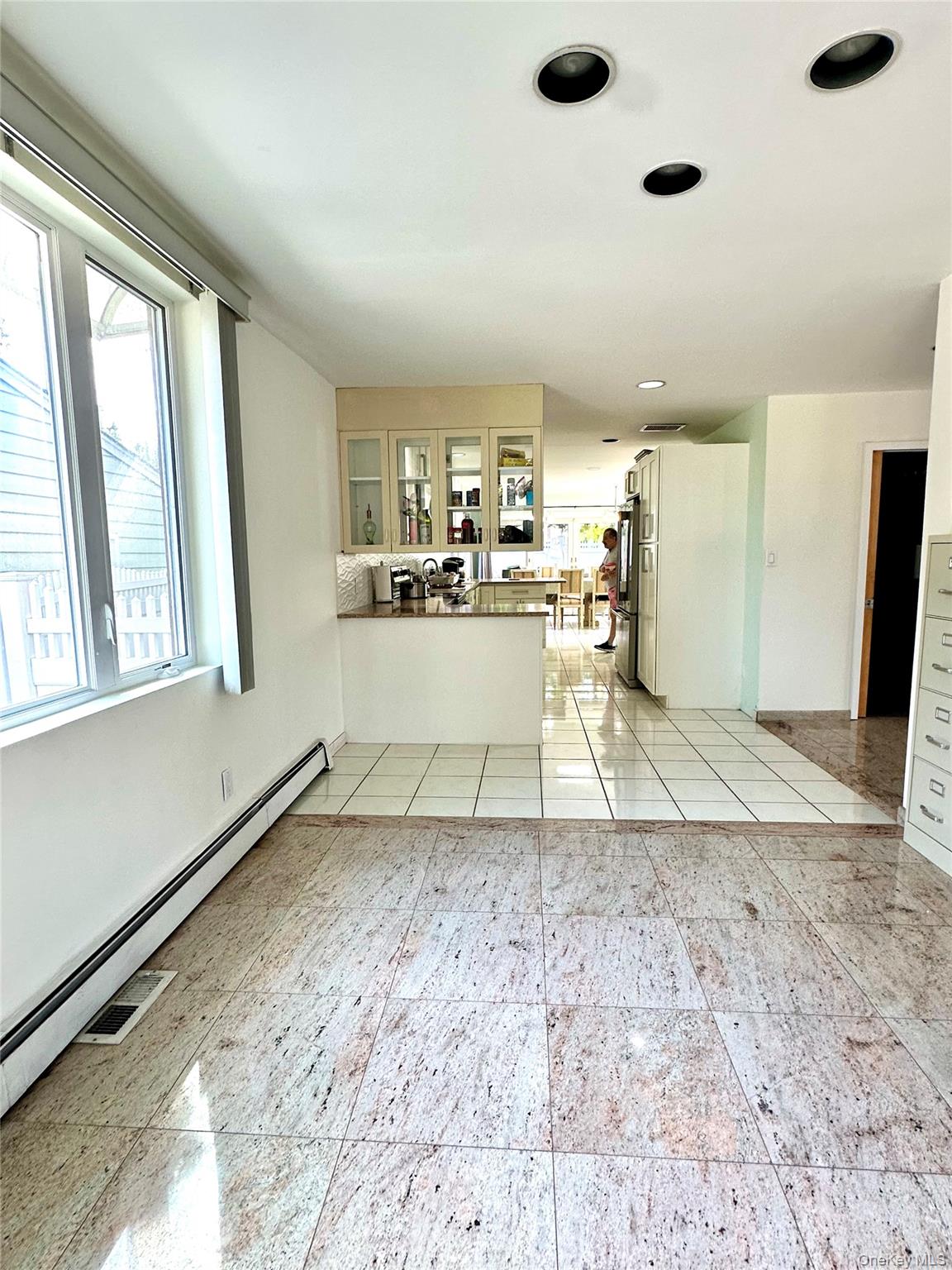 1027 Windermere Road Franklin Square, NY 11010 - Photo 23 of 43 a living room with a couch and a dresser next to a window