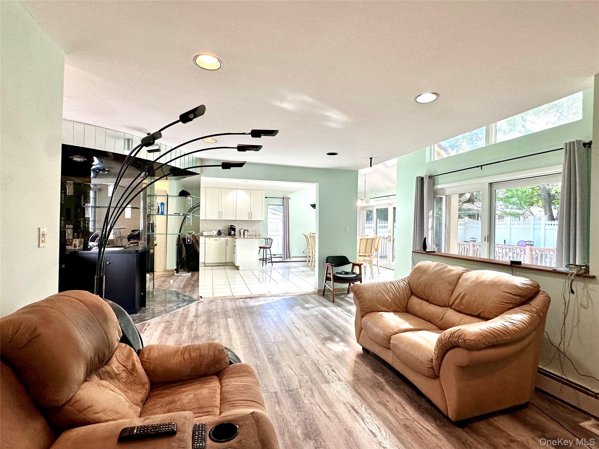 1027 Windermere Road Franklin Square, NY 11010 - Photo 26 of 43 a living room with furniture a ceiling fan and a large window
