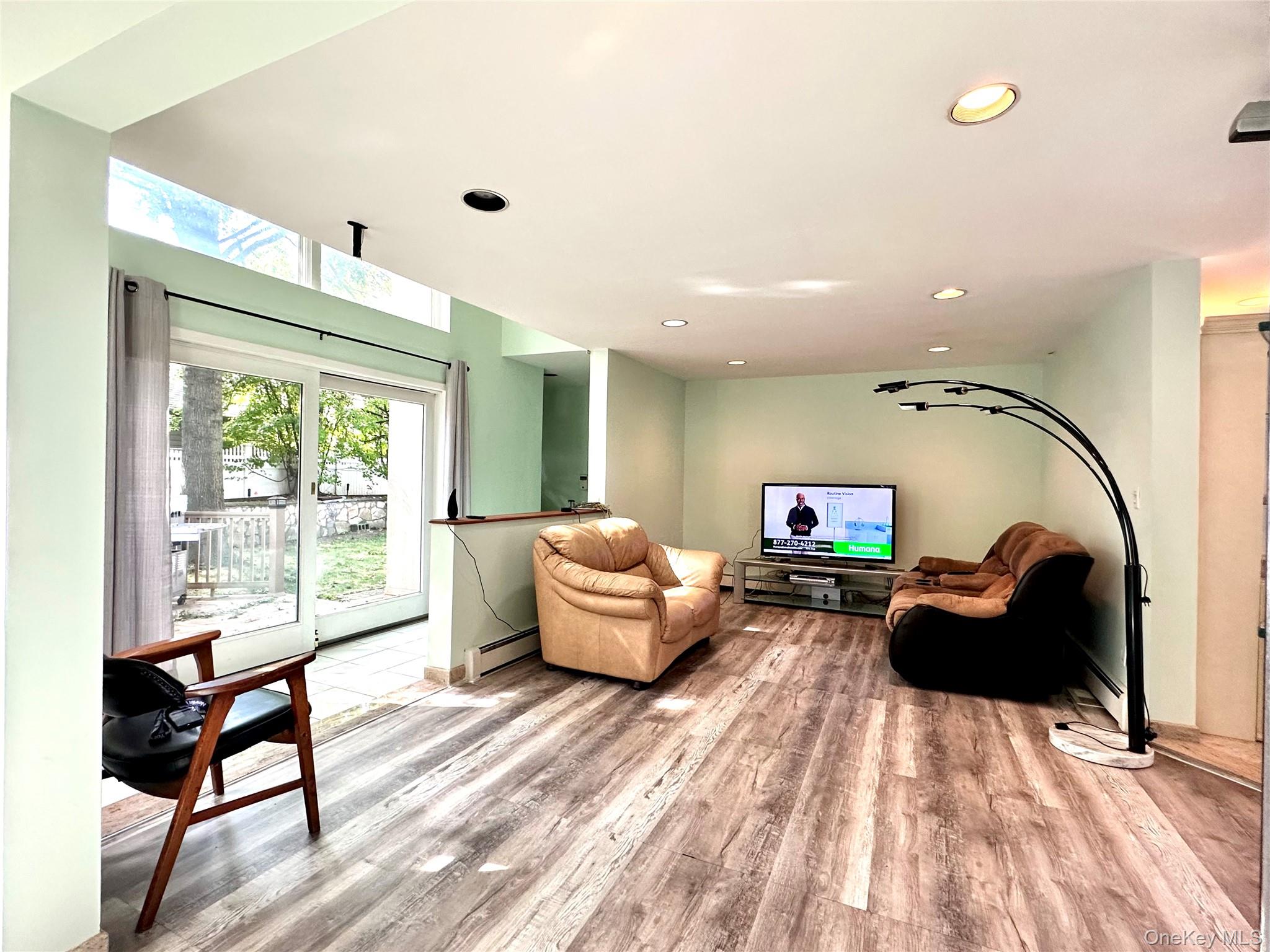 1027 Windermere Road Franklin Square, NY 11010 - Photo 27 of 43 a living room with furniture a large window and wooden floor