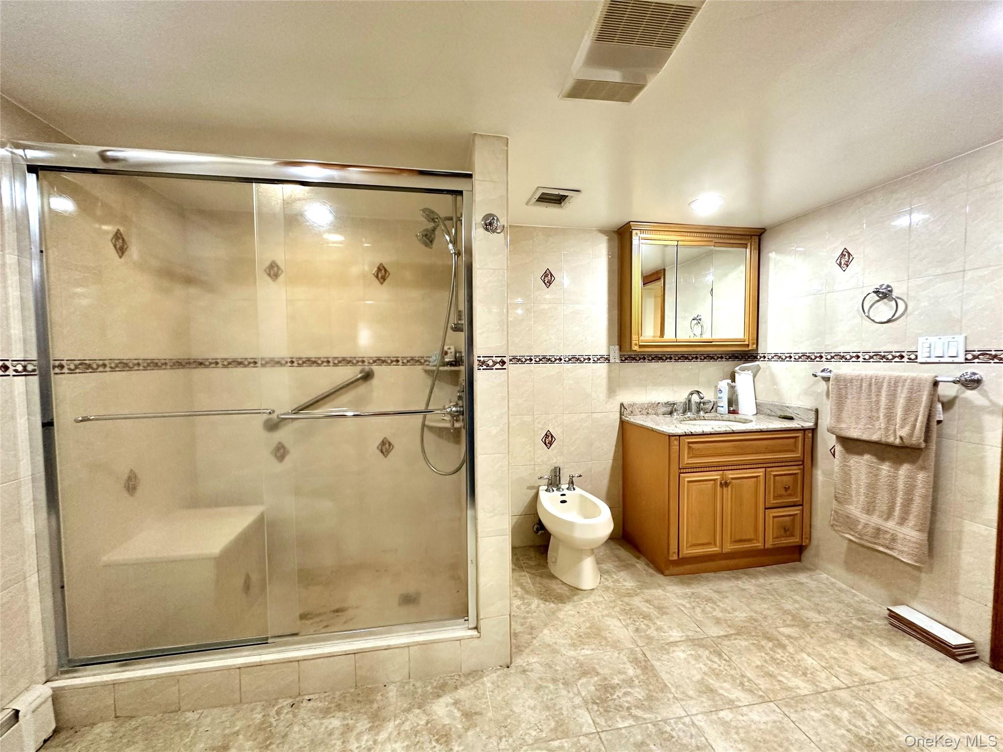 1027 Windermere Road Franklin Square, NY 11010 - Photo 33 of 43 a bathroom with a granite countertop sink toilet and shower