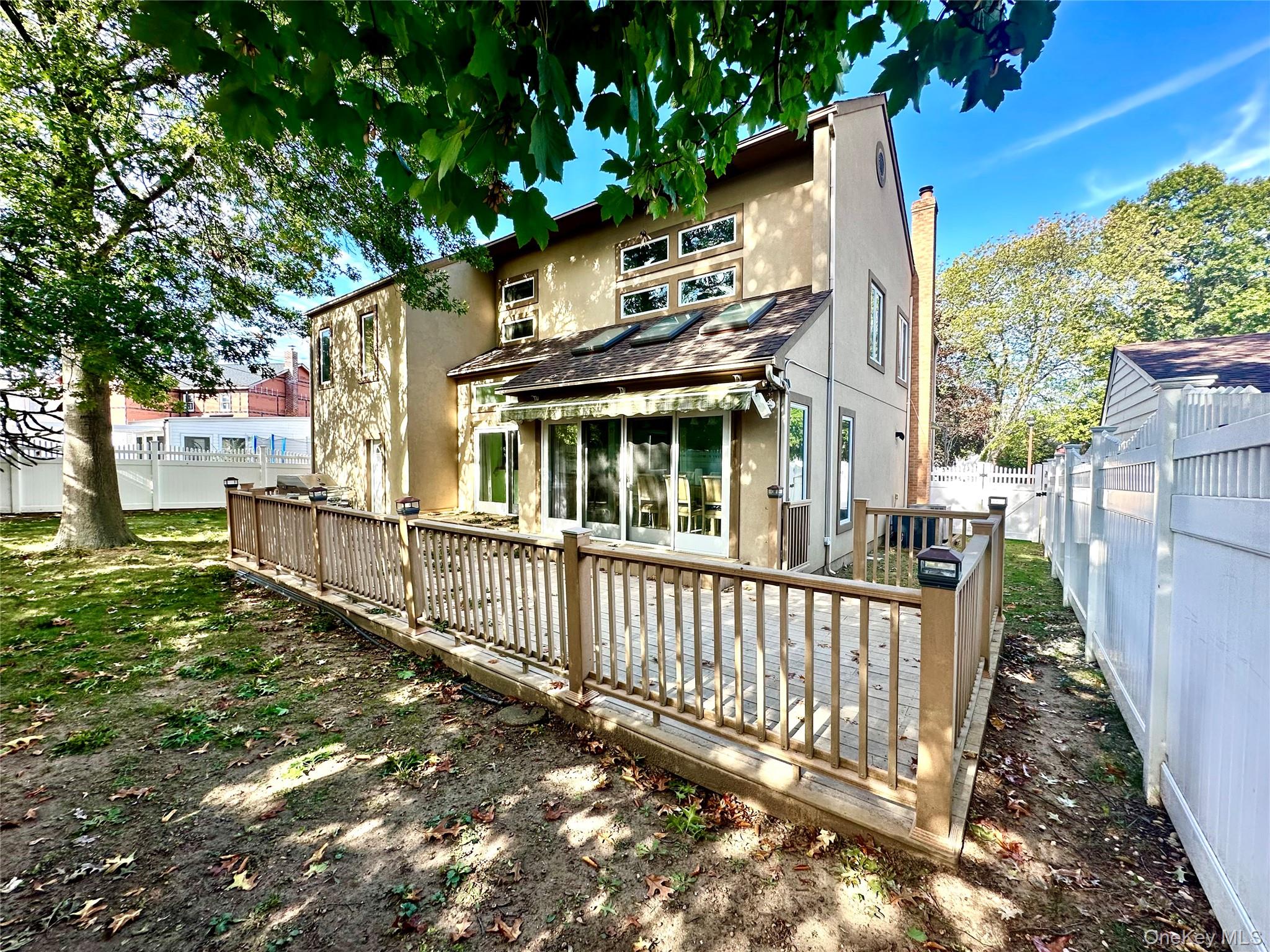 1027 Windermere Road Franklin Square, NY 11010 - Photo 40 of 43 a view of a house with a small yard and wooden fence