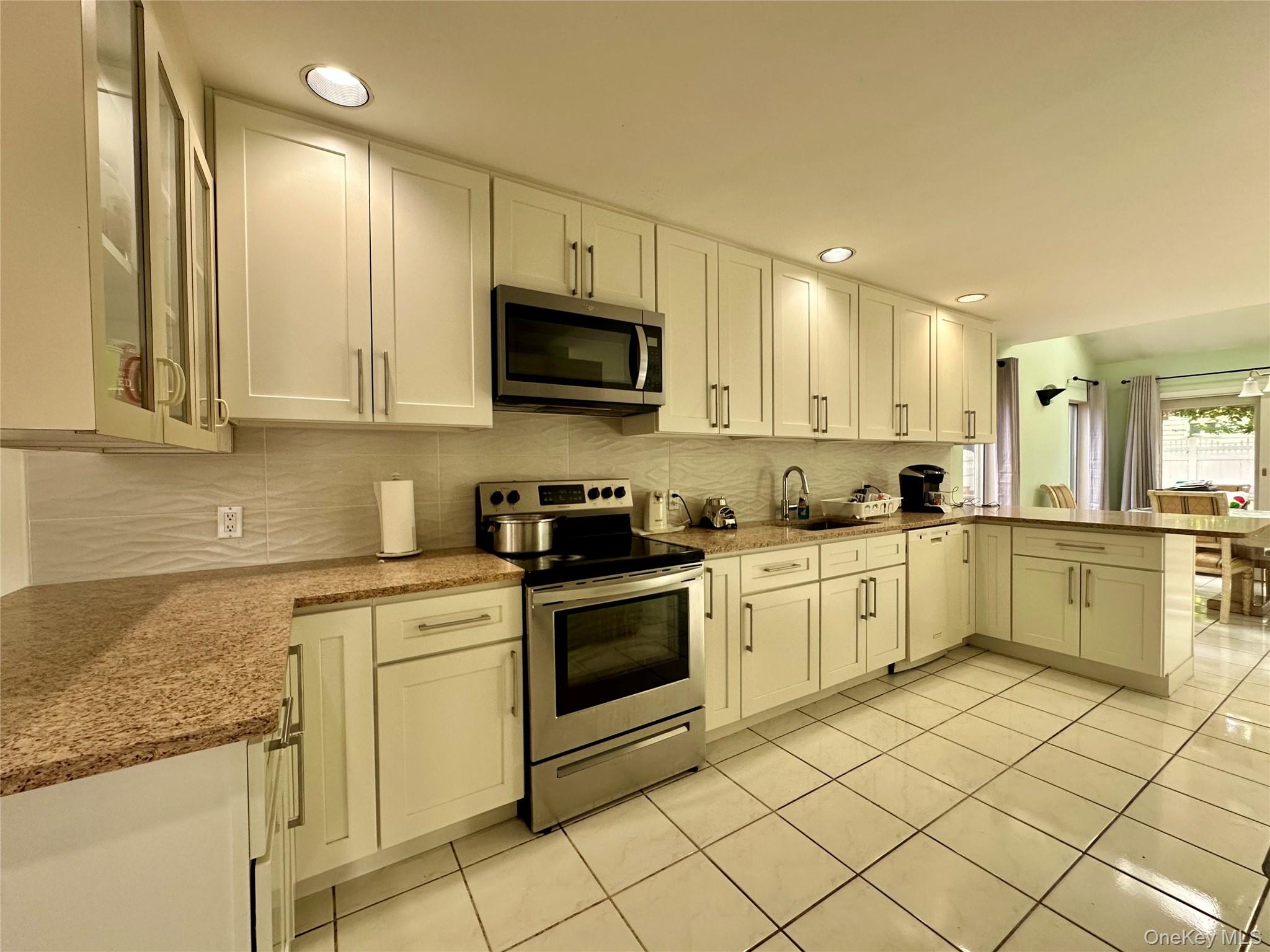 1027 Windermere Road Franklin Square, NY 11010 - Photo 4 of 43 a kitchen with a sink cabinets and appliances