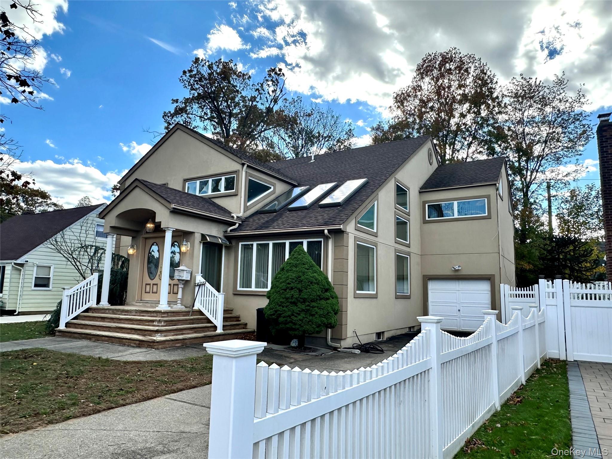 1027 Windermere Road Franklin Square, NY 11010 - Photo 43 of 43 a front view of a house with garden