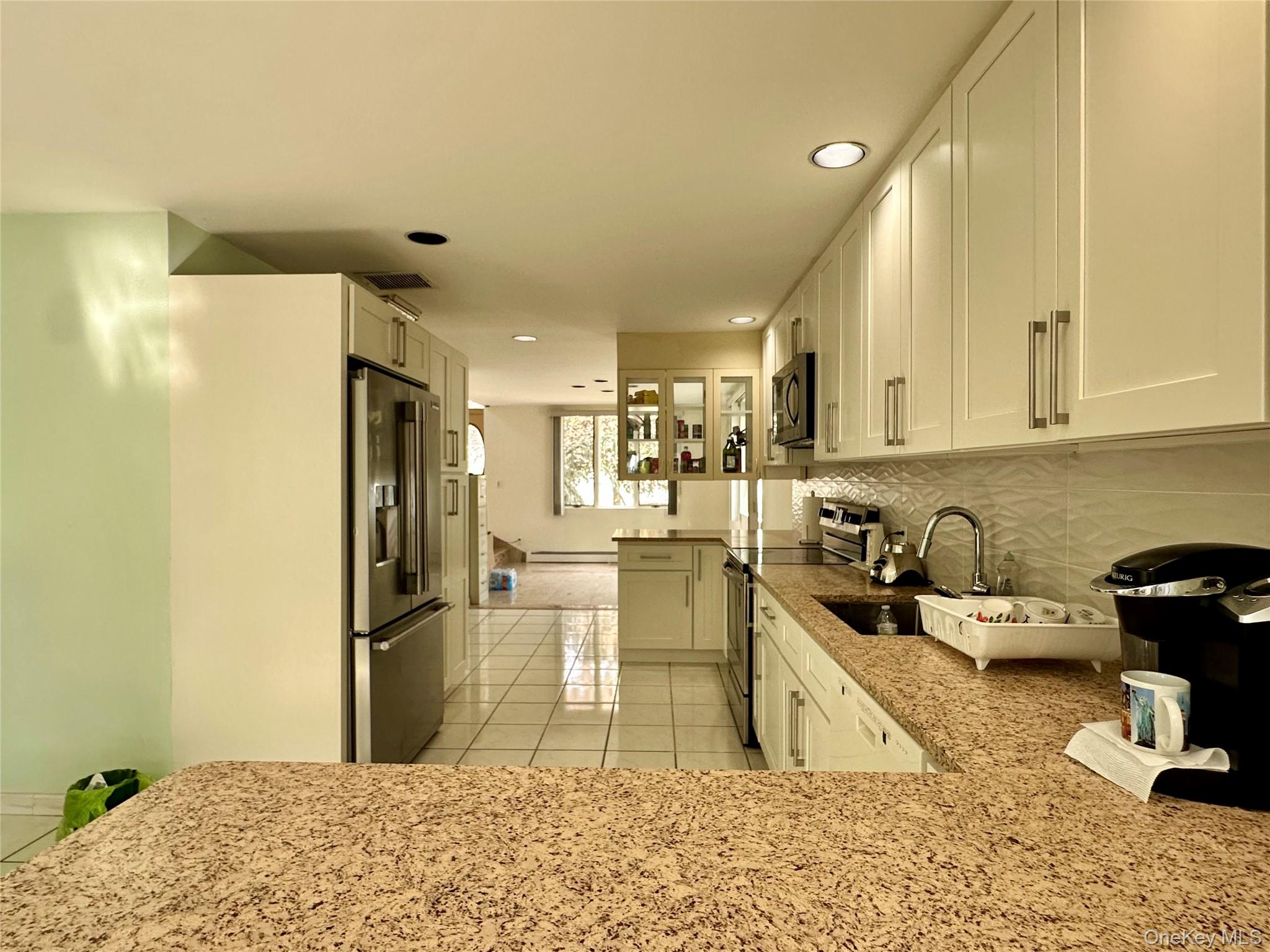 1027 Windermere Road Franklin Square, NY 11010 - Photo 6 of 43 a kitchen with a refrigerator and a sink