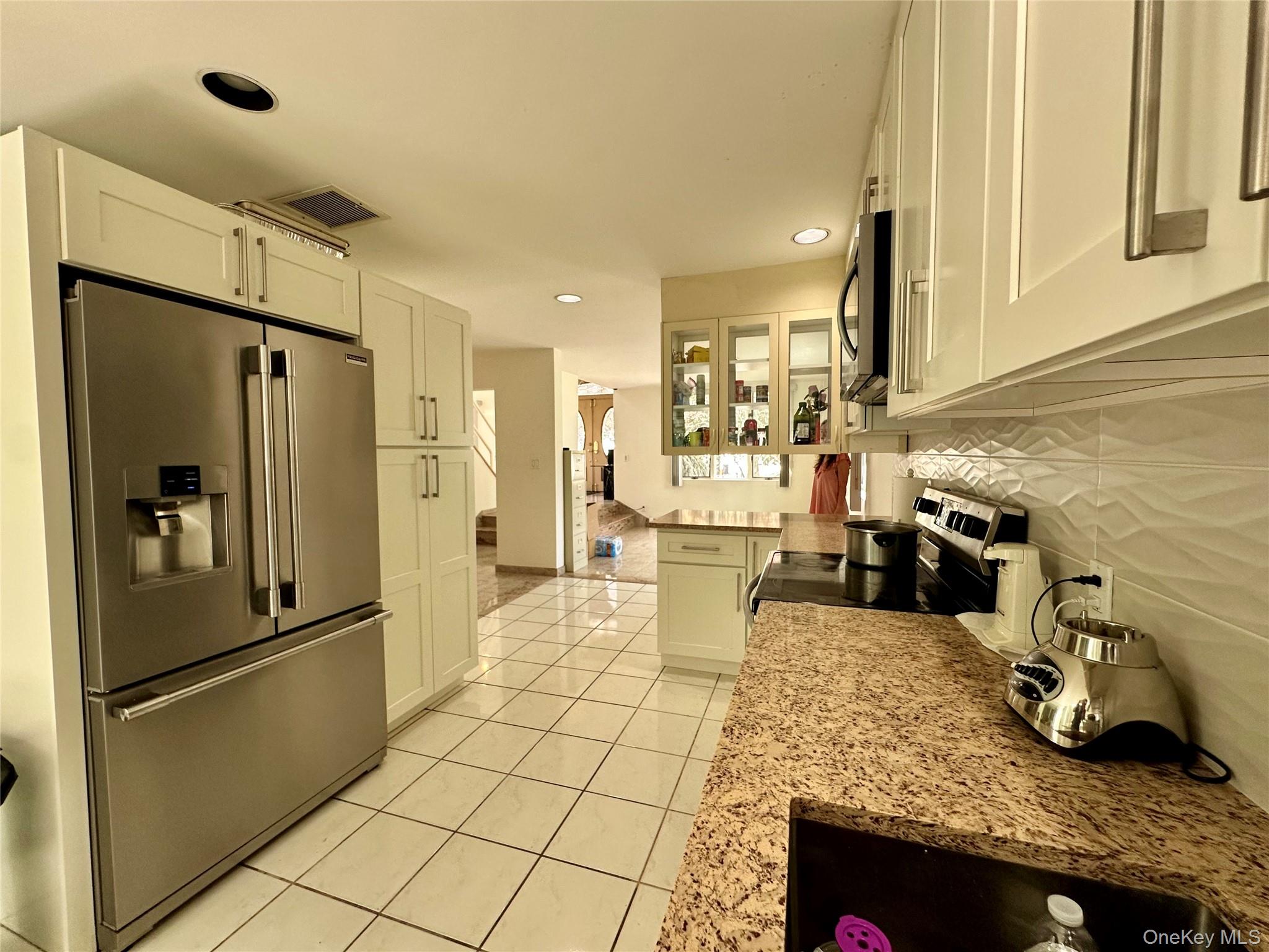 1027 Windermere Road Franklin Square, NY 11010 - Photo 7 of 43 a kitchen with granite countertop a refrigerator and a sink