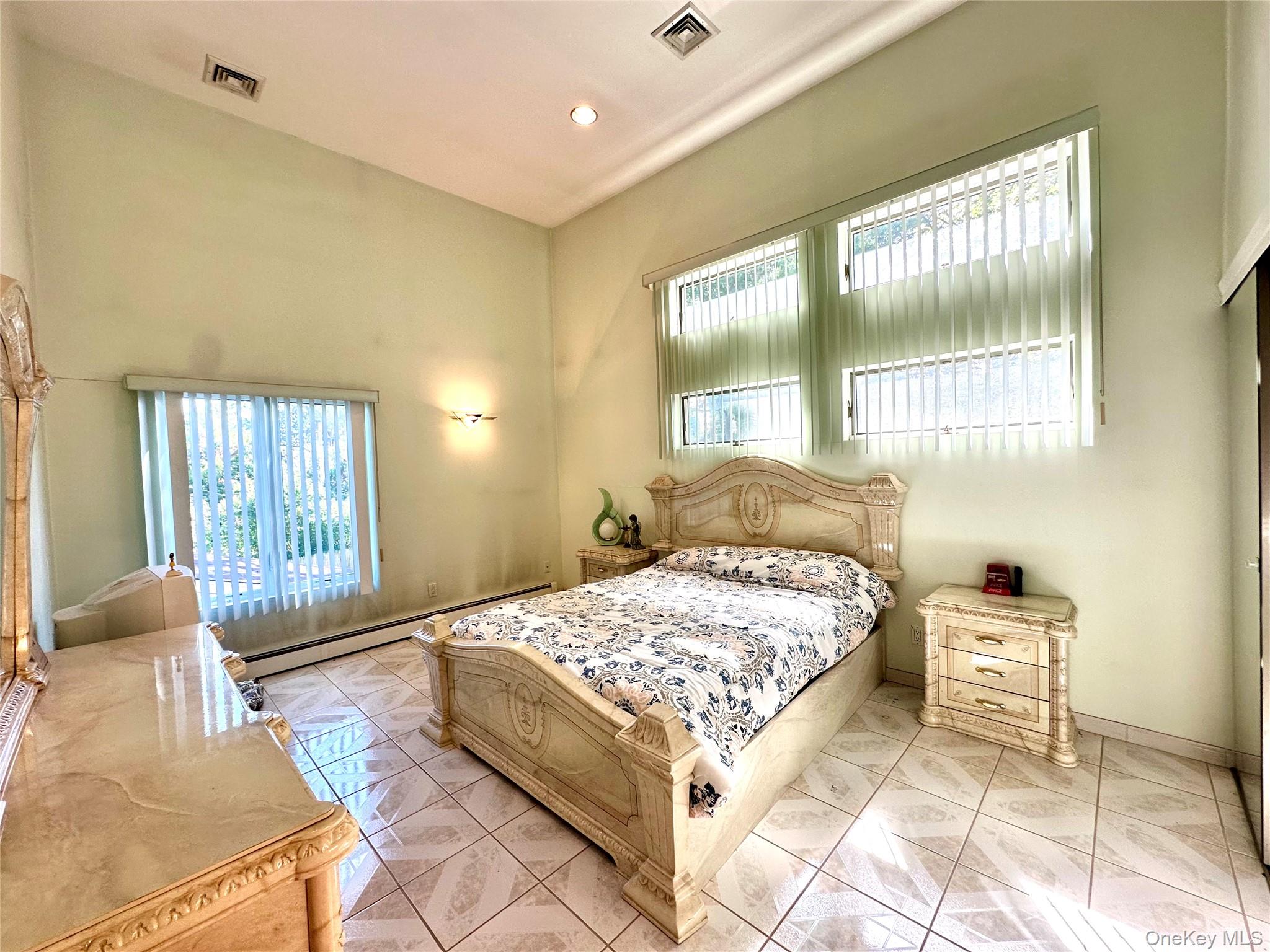 1027 Windermere Road Franklin Square, NY 11010 - Photo 8 of 43 a bedroom with a bed and wooden floor