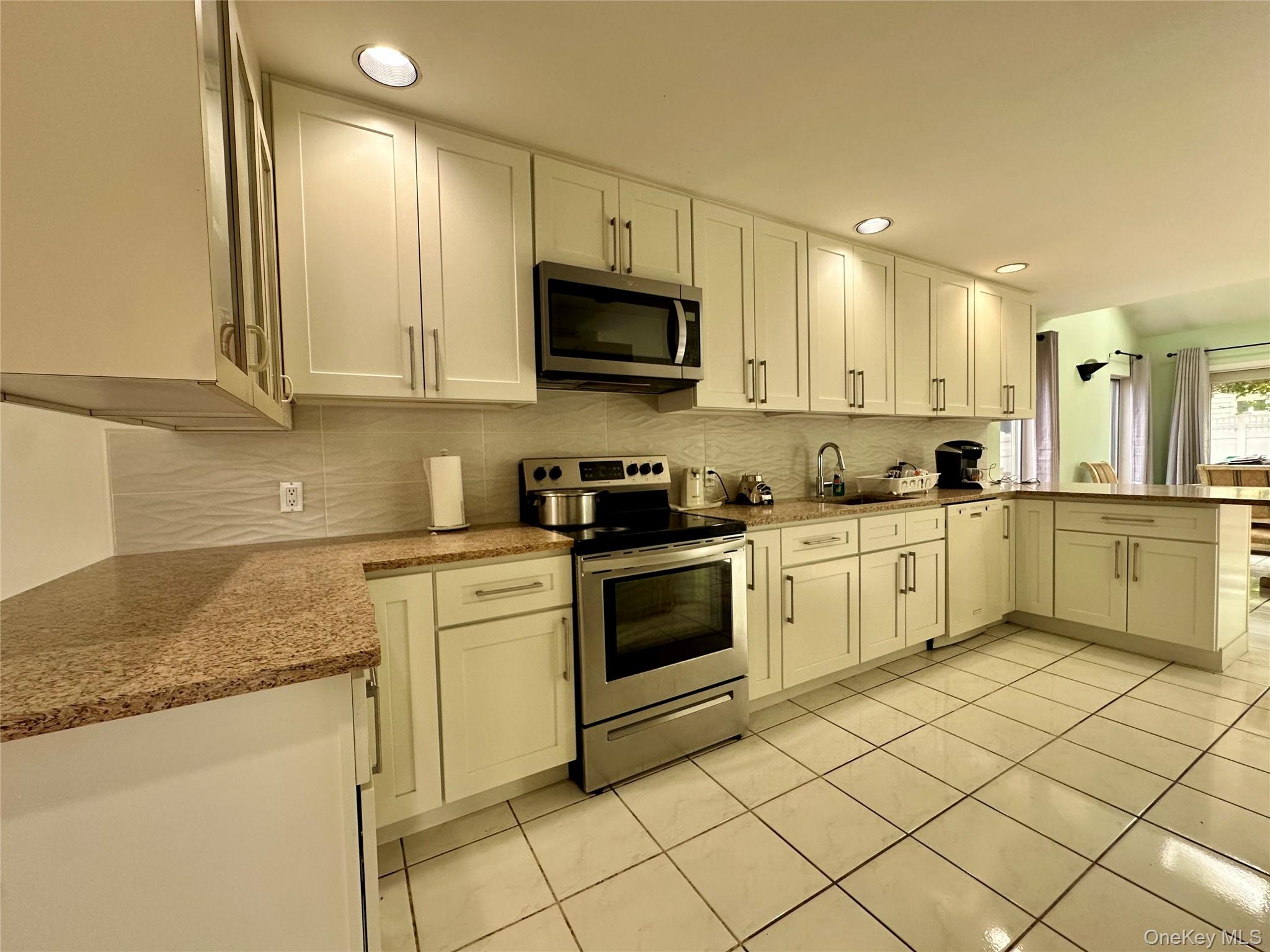 1027 Windermere Road Franklin Square, NY 11010 - Photo 9 of 43 a kitchen with a sink cabinets and window