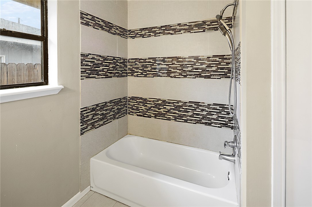 314 Moss Street Bryan, TX 77803 - Photo 13 of 18 a bathroom with a bathtub and a shower