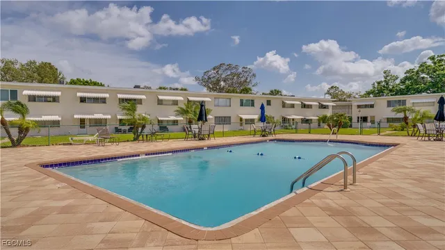 a view of a swimming pool with an outdoor seating