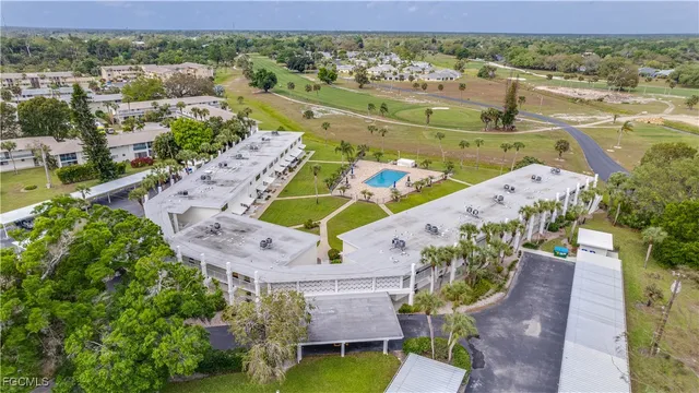 an aerial view of a house with a garden and lake view